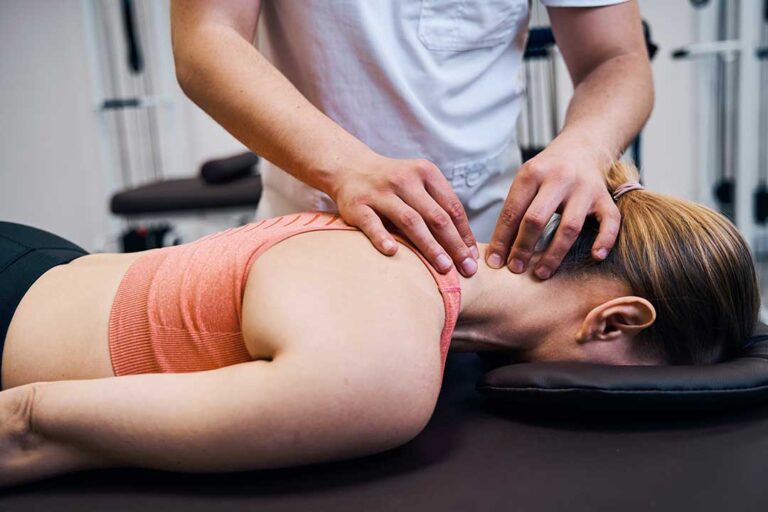 A person sitting at a desk with an upright posture, performing a gentle neck stretch.